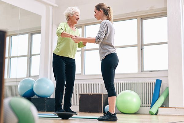 A therapist works with a patient on balance exercises. Healthy Walk Physical Therapy and Rehabilitation Iselin, NJ